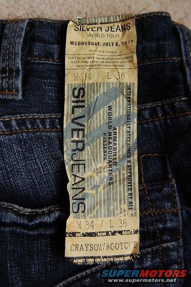 Close-up of a Silver Jeans tag on denim pants, showing size W34 L36 and style Grayson/Bootcut
