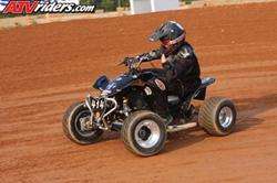 ATV riders.com watermark on photo of person on black ATV