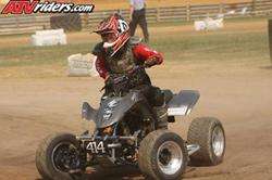 Four-wheeler with rider in red helmet, number 414 visible