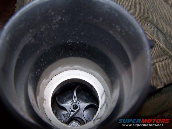 Inside of an intake manifold with a black plastic flap visible