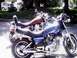 1982 Yamaha Virago - A blue motorcycle with flame graphics is parked next to a red motorcycle.