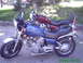 1982 Yamaha Virago - Two motorcycles are parked next to each other in an outdoor setting. The blue motorcycle has flame graphics.