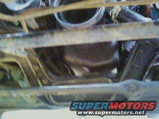 Underside view of a vehicle, showing the engine oil pan and frame