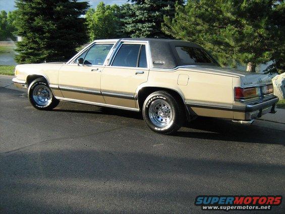 1988 Mercury Grand Marquis sedan, tan with brown trim, black vinyl top, chrome wheels