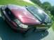 2004 Ford Crown Victoria - A maroon Ford Crown Victoria is parked on pavement with a grassy area in the background.