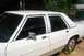 1991 Ford Crown Victoria LTD - The side profile of a white sedan shows its tinted windows and chrome accents.