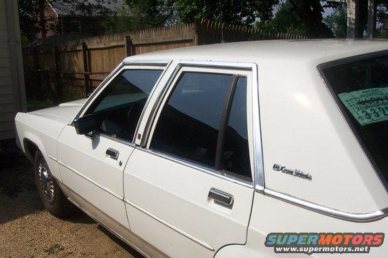 Side view of a white 1991 Ford Crown Victoria LTD with tinted windows