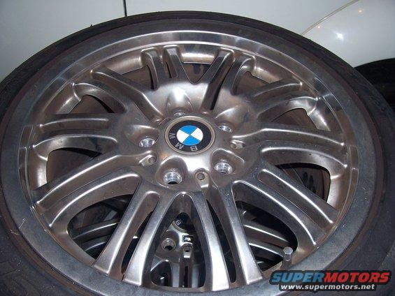 Silver BMW alloy wheel with a black and blue BMW logo in the center