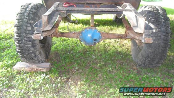 Rear axle and suspension of a vehicle with large tires. The axle is painted blue