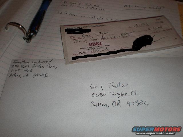 Check and envelope with handwritten addresses and details