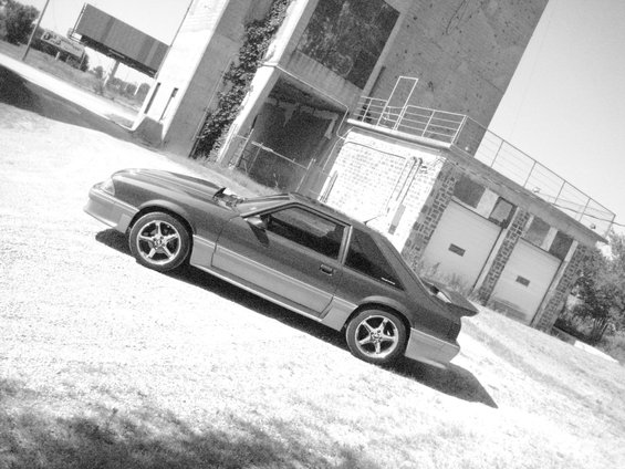 Dark 1990 Ford Mustang 3q-front view with a spoiler