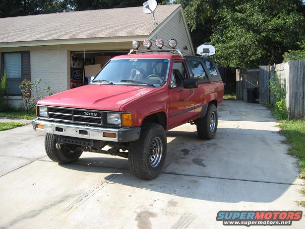 1987 Toyota 4Runner with aftermarket lights on roof rack and satellite dish on roof
