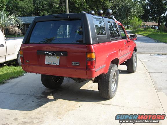 Red 1987 Toyota 4Runner parked on driveway, seen from rear