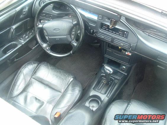 1993 Ford Taurus interior with black leather seats, dashboard, steering wheel, and center console