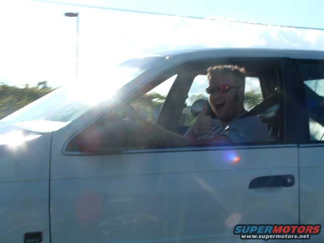 White 1993 Ford Taurus side view with a man giving a thumbs up