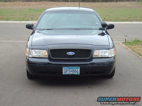 Dark blue Ford Crown Victoria front view, license plate SPT-866, with a black grille and Ford emblem