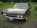 1970 Ford Falcon - Front view of a 1970 Ford Torino, showing its unique grille and dual headlights. The year is visible on the windshield.