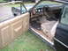1970 Ford Falcon - Interior view of a car showing the tan door panel, fabric seat, and dashboard gauges. The year is not definitively identifiable from the im…