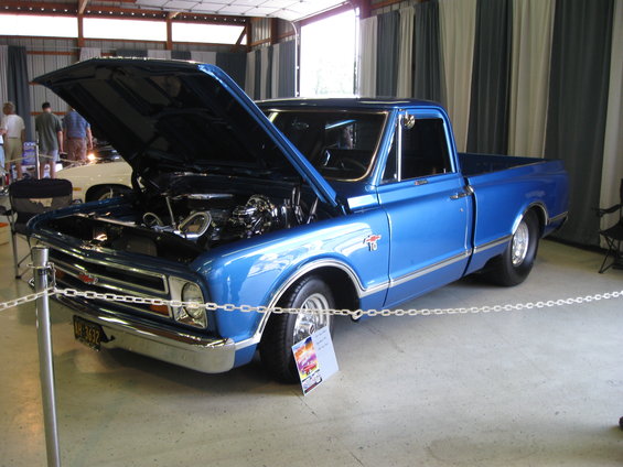 Blue 1967 Chevrolet C10 pickup truck, front 3/4 view, hood open revealing engine