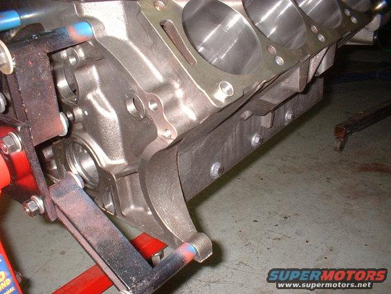 Close-up of an engine block mounted on a red engine stand
