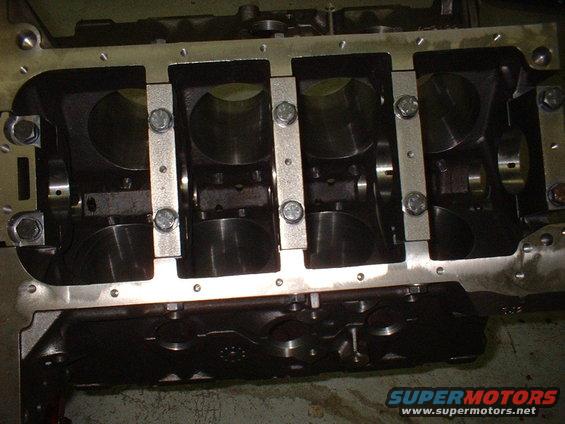 Engine block with crankshaft bearings and main caps installed