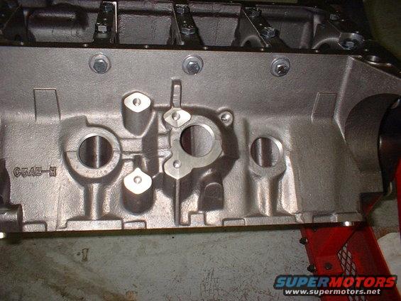 Close-up of a cast iron engine block with casting marks C5AE-H
