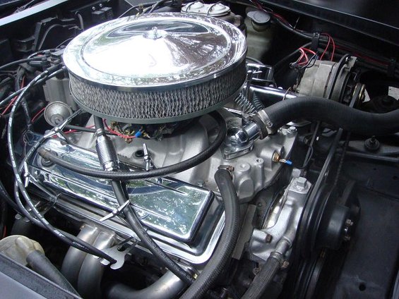 Engine bay detail showing chrome air cleaner, valve covers, and hoses