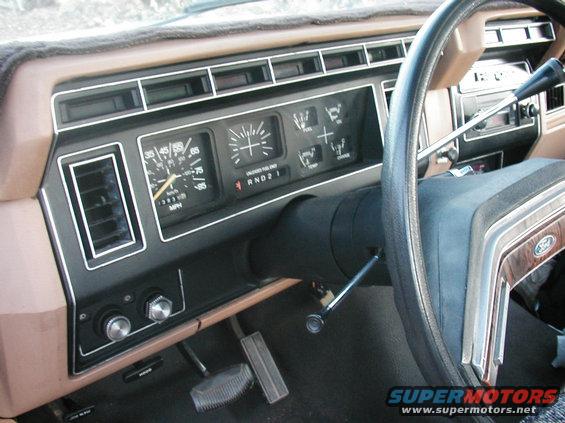 Dashboard with speedometer, fuel gauge, and temperature gauge. Steering wheel visible