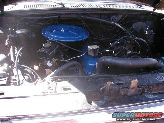 Engine bay with blue air filter housing and black hoses