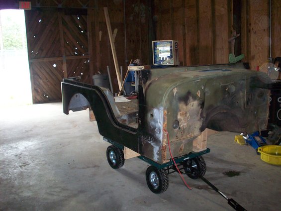 1978 Jeep CJ5 body on dolly, green paint, rust spots, in garage