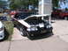 2001 Chevrolet Silverado 1500 - A black and white convertible Mustang is displayed with its hood open, revealing the engine bay. Other vehicles are visible in the backgrou…
