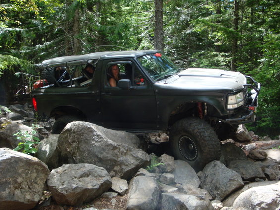 Dark green 1992 Ford Bronco navigating rocks
