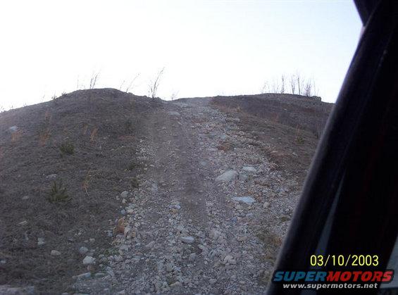 100_0070-(medium).jpg The hill I'm about to climb is divided into 7 sections. 3 flats and 4 smaller hills. The first part is pretty steep, then the 2nd (the second is shown in this picture),the 3rd (which is the steepest part), and then the 4th which is pretty mellow. This doesn't look to steep because I was starting up the 2nd hill when I took this picture