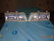 1995 Ford Taurus - This image shows a pair of clear headlights, likely for a vehicle, resting on a blue tarp.