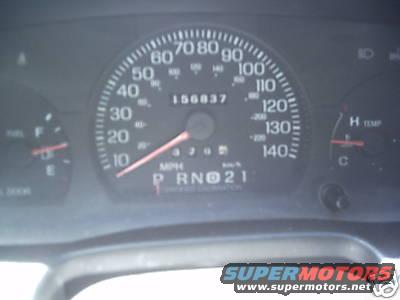 Dashboard gauges showing 156,837 miles, MPH, and temperature