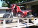1991 Ford Bronco - A red three-wheeled ATV with "Fox" graphics is secured to a trailer.