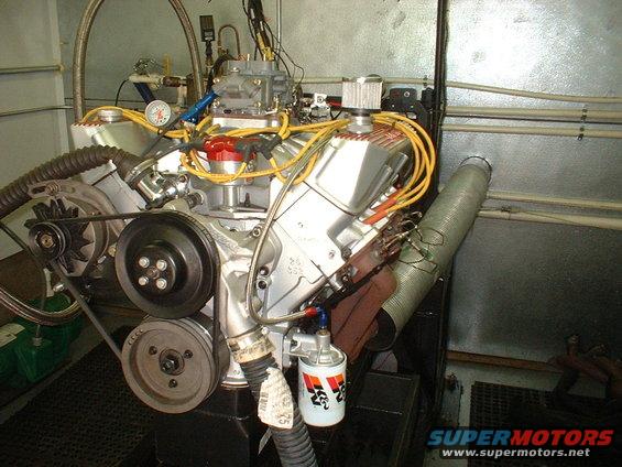Engine on a test stand with K&N oil filter and yellow spark plug wires