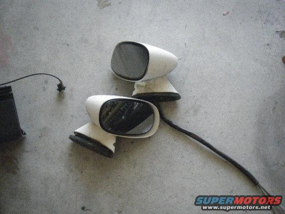 Pair of white side mirrors with black bases and wires
