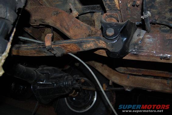 Undercarriage view showing leaf springs, differential, and suspension components. Some rust is visible