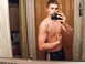 1991 GMC Jimmy - A man poses for a mirror selfie, holding a camera and flexing his arm.
