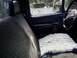 1994 Ford F-250 - The interior of a truck cab is shown, with a sheepskin cover on the passenger seat and a view through the window.