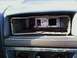 1994 Ford F-250 - Interior view of a dashboard with the car stereo mount removed, showing exposed wiring and metal components.