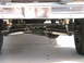 1985 Ford Bronco - Close-up of front steering linkage and stabilizer shocks.