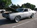 1969 Ford Torino - This 1969 Ford Torino is in primer and has its hood open, parked outdoors.
