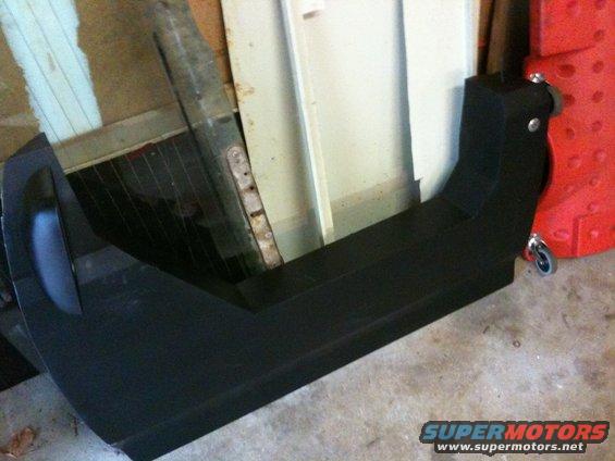 Black aftermarket rear bumper with tow hitch receiver