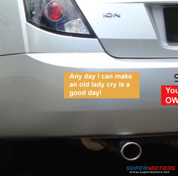 Silver car bumper with an orange sticker saying 'Any day I can make an old lady cry is a good day!' and a red sticker partially visible
