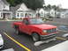 1992 Ford Ranger - Red 1992 Ford Ranger pickup truck parked in a lot with apartment buildings in the background.