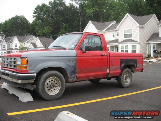 Red and gray Ford Ranger pickup truck parked in a lot