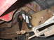 1992 Ford Ranger - Close-up view of the undercarriage of a truck, focusing on suspension components and frame rust.