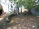 1981 Kawasaki Bayou - Aircraft fuselage and engine parts are visible in a grassy outdoor area with trees and a shed.